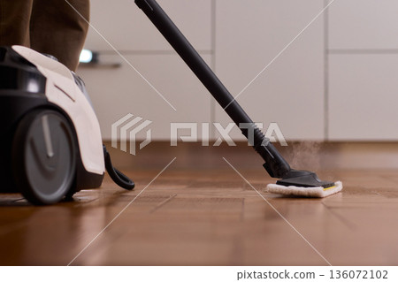Professional parqueting cleaning visuals, Ecofriendly vapor cleaning for wooden floors, Scene showcasing deep cleaning technology with vapor and steaming effect on wooden flooring 136072102