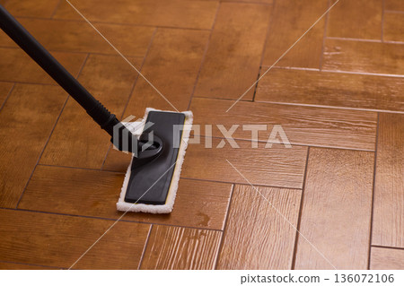Professional parqueting cleaning visuals, Ecofriendly vapor cleaning for wooden floors, Scene showcasing deep cleaning technology with vapor and steaming effect on wooden flooring 136072106