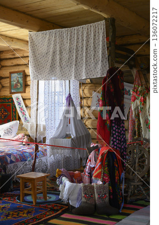The interior of a 19th-century Russian hut with a bed and a cradle suspended from the ceiling The interior of a 19th-century Russian hut with a bed and a cradle suspended from the ceiling 136072217
