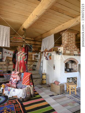 Interior of a 19th-century Russian hut with a large stove on which children slept Interior of a 19th-century Russian hut with a large stove on which children slept 136072223