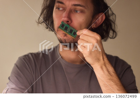 Individual carefully inspecting SODIMM memory module in detailed review, Technician performing detailed visual assessment of RAM stick with neutral lighting and focused attention Individual carefully inspecting SODIMM memory module in detailed review, Technician performing detailed visual assessment of RAM stick with neutral lighting and focused attention 136072499