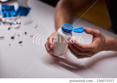 Pharmacist organizing medication bottles, Medical technician managing pill containers efficiently, Clinical staff ensuring proper storage and safety of pharmaceutical supplies 136073557