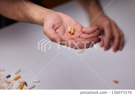 Anxious scene showing medication overload and health concerns, Clinical setting depicting patient holding pills surrounded by bottles indicating potential overdose Anxious scene showing medication overload and health concerns, Clinical setting depicting patient holding pills surrounded by bottles indicating potential overdose 136073576