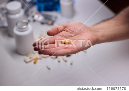 Anxious scene showing medication overload and health concerns, Clinical setting depicting patient holding pills surrounded by bottles indicating potential overdose Anxious scene showing medication overload and health concerns, Clinical setting depicting patient holding pills surrounded by bottles indicating potential overdose 136073578