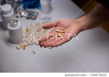 Anxious scene showing medication overload and health concerns, Clinical setting depicting patient holding pills surrounded by bottles indicating potential overdose Anxious scene showing medication overload and health concerns, Clinical setting depicting patient holding pills surrounded by bottles indicating potential overdose 136073620