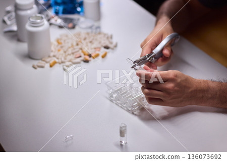 Cleaning and mixing medicines with precision craftsmanship, Detailed scene of meticulous drug processing involving tablet grinding and precise pharmaceutical handling Cleaning and mixing medicines with precision craftsmanship, Detailed scene of meticulous drug processing involving tablet grinding and precise pharmaceutical handling 136073692