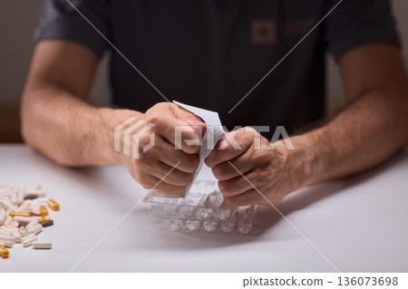 Cleaning and mixing medicines with precision craftsmanship, Detailed scene of meticulous drug processing involving tablet grinding and precise pharmaceutical handling 136073698