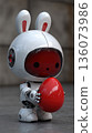 Cute Futuristic Robot Bunny Holding Red Easter Egg 136073986