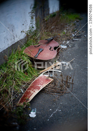 Broken stringed instrument in a ruined place 136074086