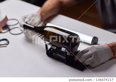 Safety Equipment Used During Glass Cutting, Workstation Setup for Safe Glass Shaping Procedure, Background of Workshop with Focus on Cutting Tools and Safety Precautions 136074117
