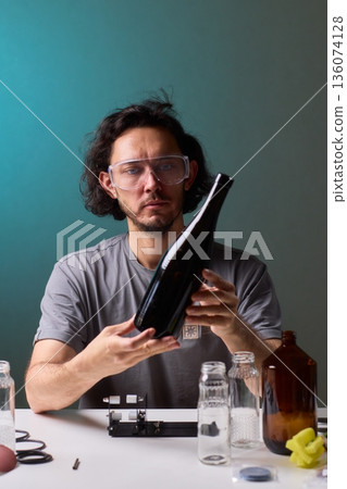 Safety Equipment Used During Glass Cutting, Workstation Setup for Safe Glass Shaping Procedure, Background of Workshop with Focus on Cutting Tools and Safety Precautions 136074128