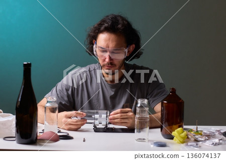 Safety Equipment Used During Glass Cutting, Workstation Setup for Safe Glass Shaping Procedure, Background of Workshop with Focus on Cutting Tools and Safety Precautions 136074137