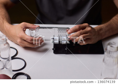 Safety Equipment Used During Glass Cutting, Workstation Setup for Safe Glass Shaping Procedure, Background of Workshop with Focus on Cutting Tools and Safety Precautions 136074139