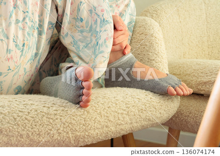 cozy domestic candid scene of unrecognizable woman in gymnastic socks on her cute nice feet with bare toes model posing concept indoor comfort zone space on chair cozy domestic candid scene of unrecognizable woman in gymnastic socks on her cute nice feet with bare toes model posing concept indoor comfort zone space on chair 136074174