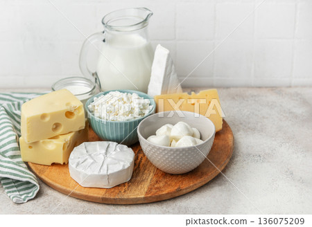 Assortment of fresh dairy products on wooden board Assortment of fresh dairy products on wooden board 136075209