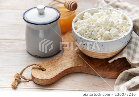 Cottage cheese in bowl with honey and sugar pot 136075216