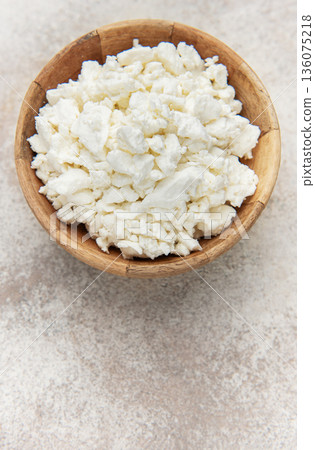 Cottage cheese in wooden bowl on rustic background Cottage cheese in wooden bowl on rustic background 136075218