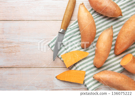 Preparing raw sweet potatoes for healthy cooking 136075222