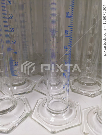 These clear glass cylinders are used to accurately measure liquid volumes in chemistry and biology experiments These clear glass cylinders are used to accurately measure liquid volumes in chemistry and biology experiments 136075304