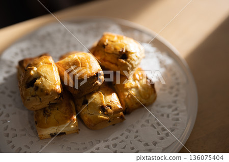 Close-up of freshly baked scones on a white plate Close-up of freshly baked scones on a white plate 136075404