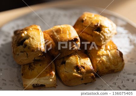 Close-up of freshly baked scones on a white plate Close-up of freshly baked scones on a white plate 136075405