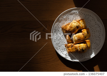 Close-up of freshly baked scones on a white plate Close-up of freshly baked scones on a white plate 136075407