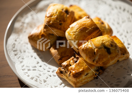 Close-up of freshly baked scones on a white plate 136075408