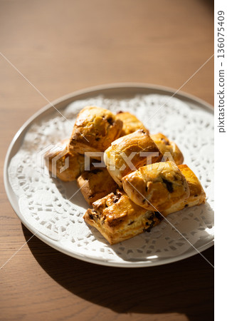 Close-up of freshly baked scones on a white plate Close-up of freshly baked scones on a white plate 136075409