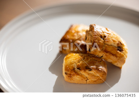 Scones on a white plate on a wooden table with copy space Scones on a white plate on a wooden table with copy space 136075435