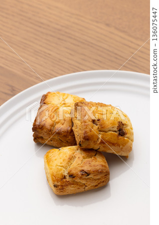 Scones on a white plate on a wooden table with copy space Scones on a white plate on a wooden table with copy space 136075447
