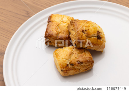 Scones on a white plate on a wooden table with copy space Scones on a white plate on a wooden table with copy space 136075449