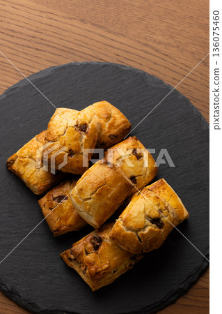 Scones on a black plate lit by natural light from a window Scones on a black plate lit by natural light from a window 136075460