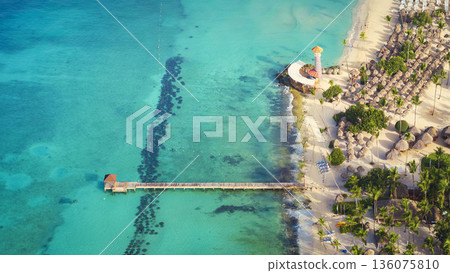 Top view of a lighthouse and wooden pier on Bayahibe beach with turquoise sea Top view of a lighthouse and wooden pier on Bayahibe beach with turquoise sea 136075810