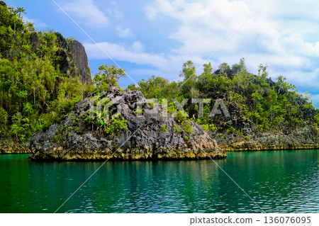 beautiful view of island and sea with clear sky background, West Papua, Indonesia beautiful view of island and sea with clear sky background, West Papua, Indonesia 136076095