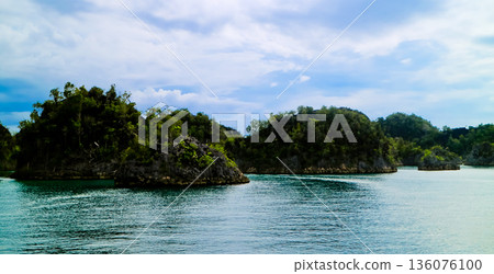 beautiful view of island and sea with clear sky background, West Papua, Indonesia beautiful view of island and sea with clear sky background, West Papua, Indonesia 136076100