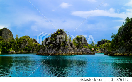 beautiful view of island and sea with clear sky background, West Papua, Indonesia 136076112