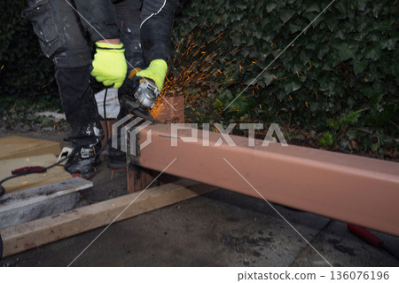 Angle Grinder Cutting Steel Beam with Flying Sparks Angle Grinder Cutting Steel Beam with Flying Sparks 136076196
