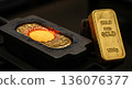 Liquid gold being poured into a mold during the gold bar manufacturing process and an image of the finished product 136076377