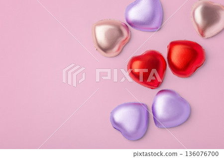 Heart chocolate with colorful foil wrapped on pink background, valentines day and love concept, top view 136076700