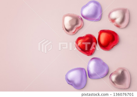 Valentines day and love background, heart chocolate with colorful foil wrapped on pink background, copy space 136076701