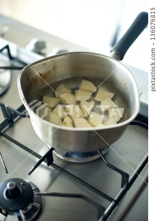 Cut potatoes being boiled in a pot Cut potatoes being boiled in a pot 136076815