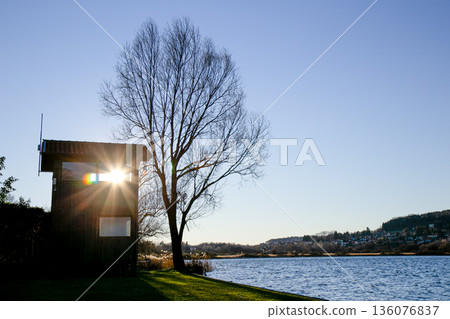 Soft light beam crossing an interior opening toward shimmering water Soft light beam crossing an interior opening toward shimmering water 136076837