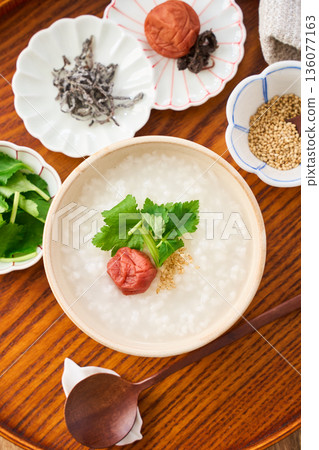 Warm white rice porridge with pickled plum and mitsuba Warm white rice porridge with pickled plum and mitsuba 136077163