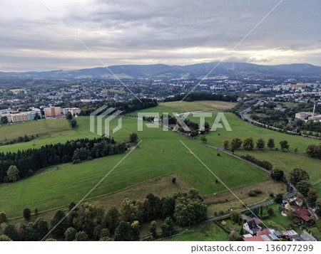 City Outskirts Landscape, Nightfall Over Sprawling Rural Fields With Scattered Trees And Distant Cityscape City Outskirts Landscape, Nightfall Over Sprawling Rural Fields With Scattered Trees And Distant Cityscape 136077299
