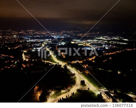 Night Aerial View Of Industrial Zones With Warehouses And Loading Areas Illuminated Brightly 136077318