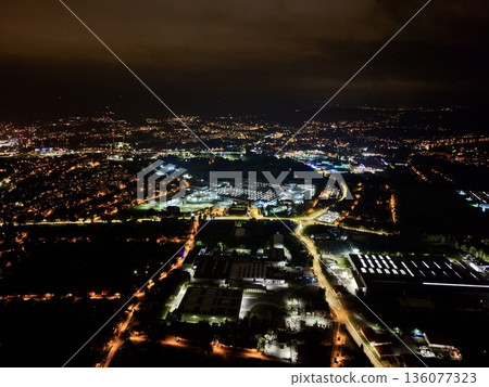 Urban Factory Area Illuminated Beneath Cloudy Sky With Organized Grid And Bustling Activity Urban Factory Area Illuminated Beneath Cloudy Sky With Organized Grid And Bustling Activity 136077323