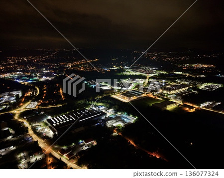 Industrial Logistics Zone Showcases Illuminated Bays And Busy Truck Routes Against Cinematic Urban Backdrop Industrial Logistics Zone Showcases Illuminated Bays And Busy Truck Routes Against Cinematic Urban Backdrop 136077324