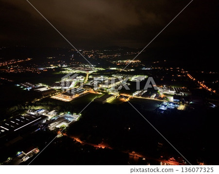 Illuminated Power Site At Night, Dark Landscape Illuminated By Extensive Energy Facility Lights Illuminated Power Site At Night, Dark Landscape Illuminated By Extensive Energy Facility Lights 136077325