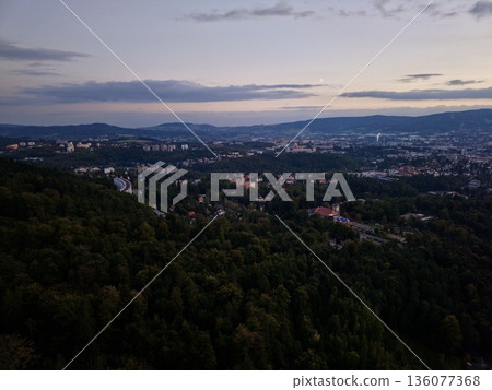 Transition From Daylight To Twilight With Silhouettes Blending Into Illuminated City Background Transition From Daylight To Twilight With Silhouettes Blending Into Illuminated City Background 136077368