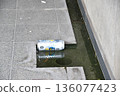 Empty aluminum cans dumped in a street gutter 136077423